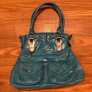 Turquoise faux leather shoulder bag. (11”x15”) 9 pockets.